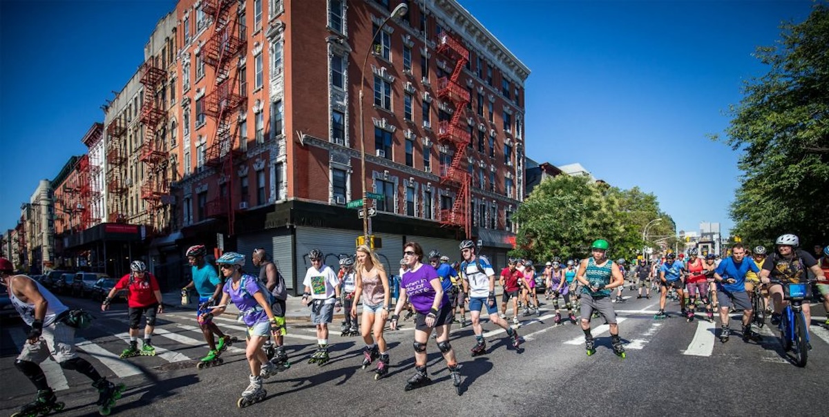 Photo of skaters cruising through a Brooklyn intersection